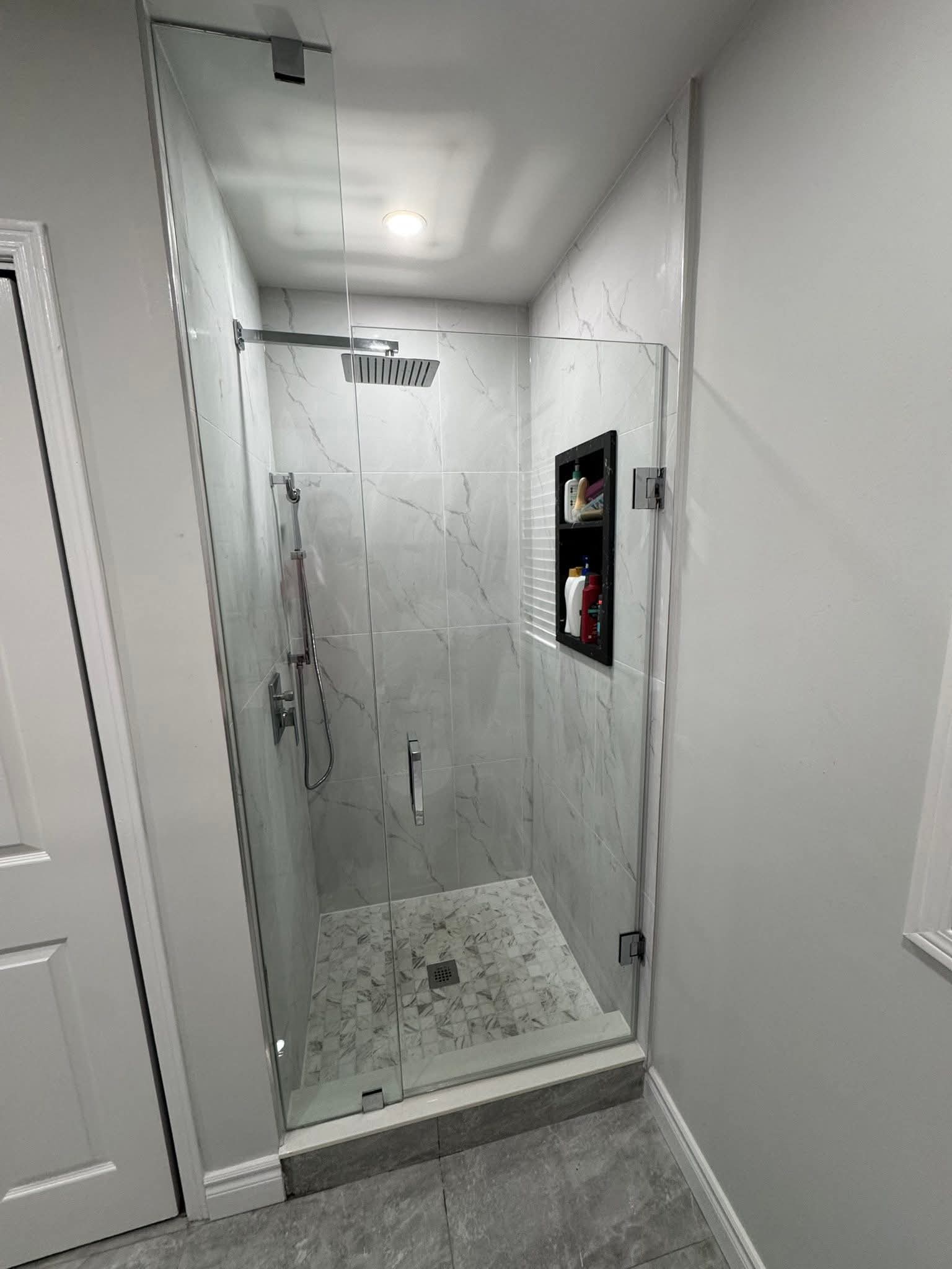 Luxury shower renovation Oakville — large format marble tile walk-in shower with rain head by Cruzz Construction