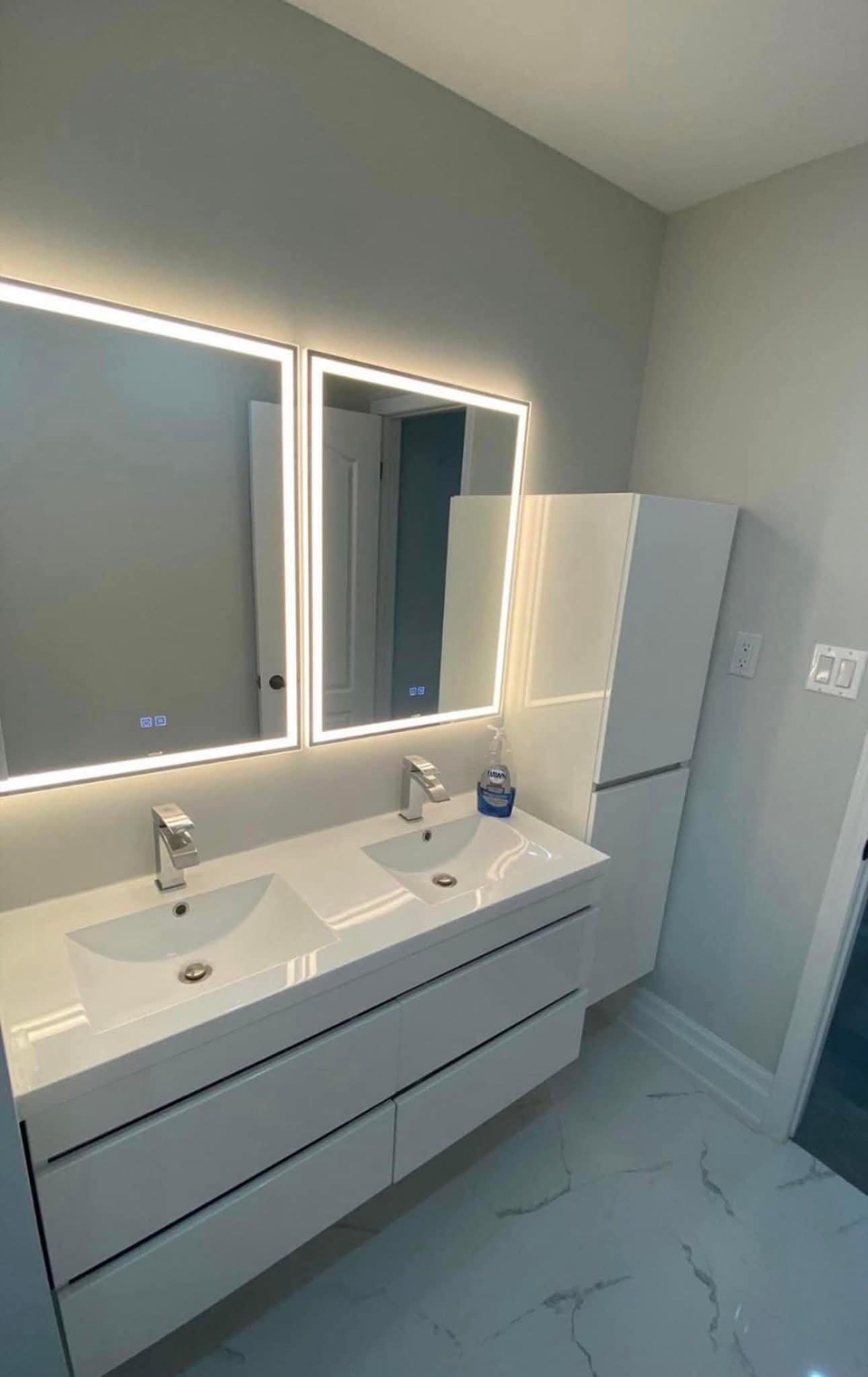 Oakville bathroom renovation — floating double vanity with dual LED backlit mirrors by Cruzz Construction
